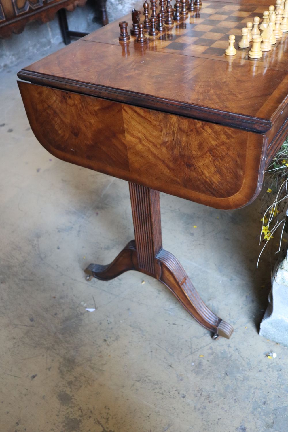 A George III style walnut sofa / games table with sliding reversible top, includes chess and backgammon pieces, width 94cm depth 60cm